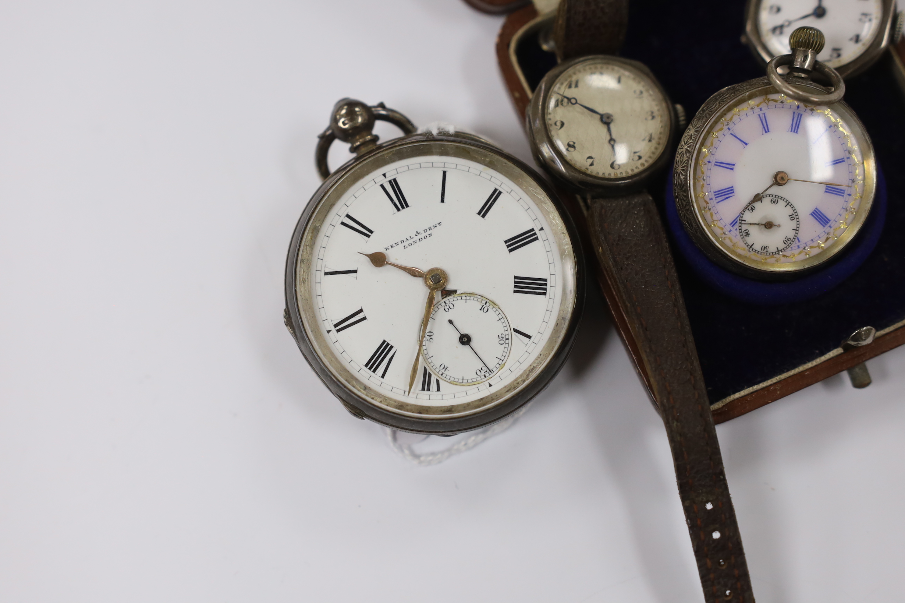 A late Victorian silver open face pocket watch, retailed by Kendall & Dent, a cased Swiss 935 standard white metal fob watch and two silver manual wind wrist watches.